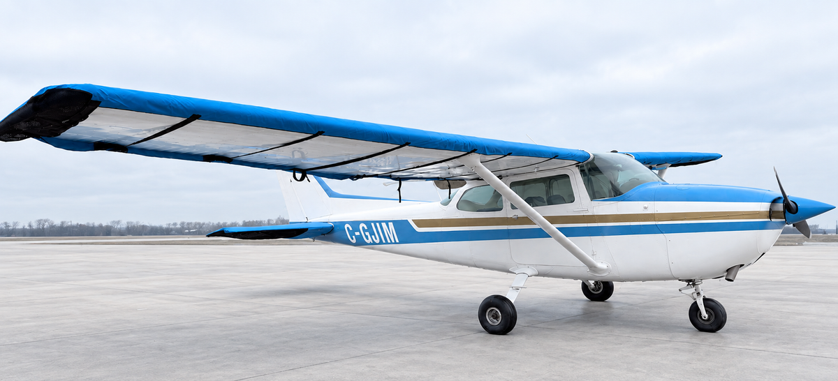 Cessna 172 with Mcovers wing and tail covers; background retouched